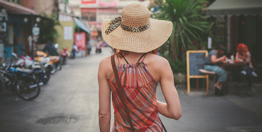 Image of woman in a hat on vacation.