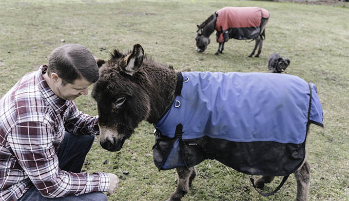 Justin Buchanan with Donkey on his farm